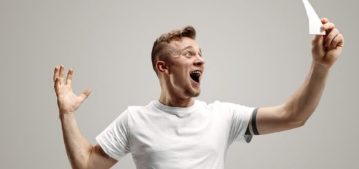 young-caucasian-man-with-surprised-happy-expression-won-bet-gray-studio-background-human-facial-emotions-betting-concept_155003-20139